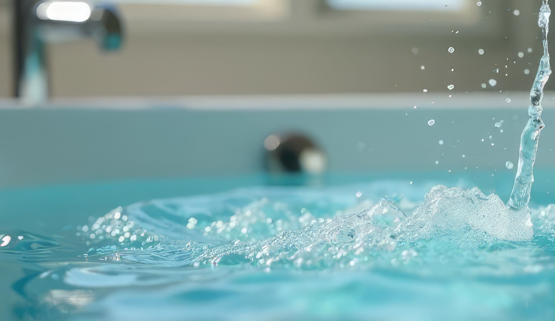 Soft water droplets falling onto the bathtub's surface